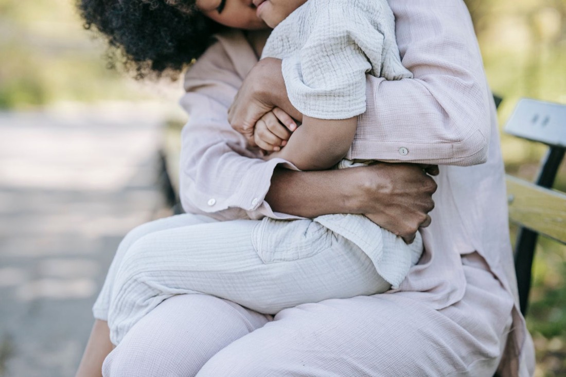 A parent holding their child close in a quiet moment